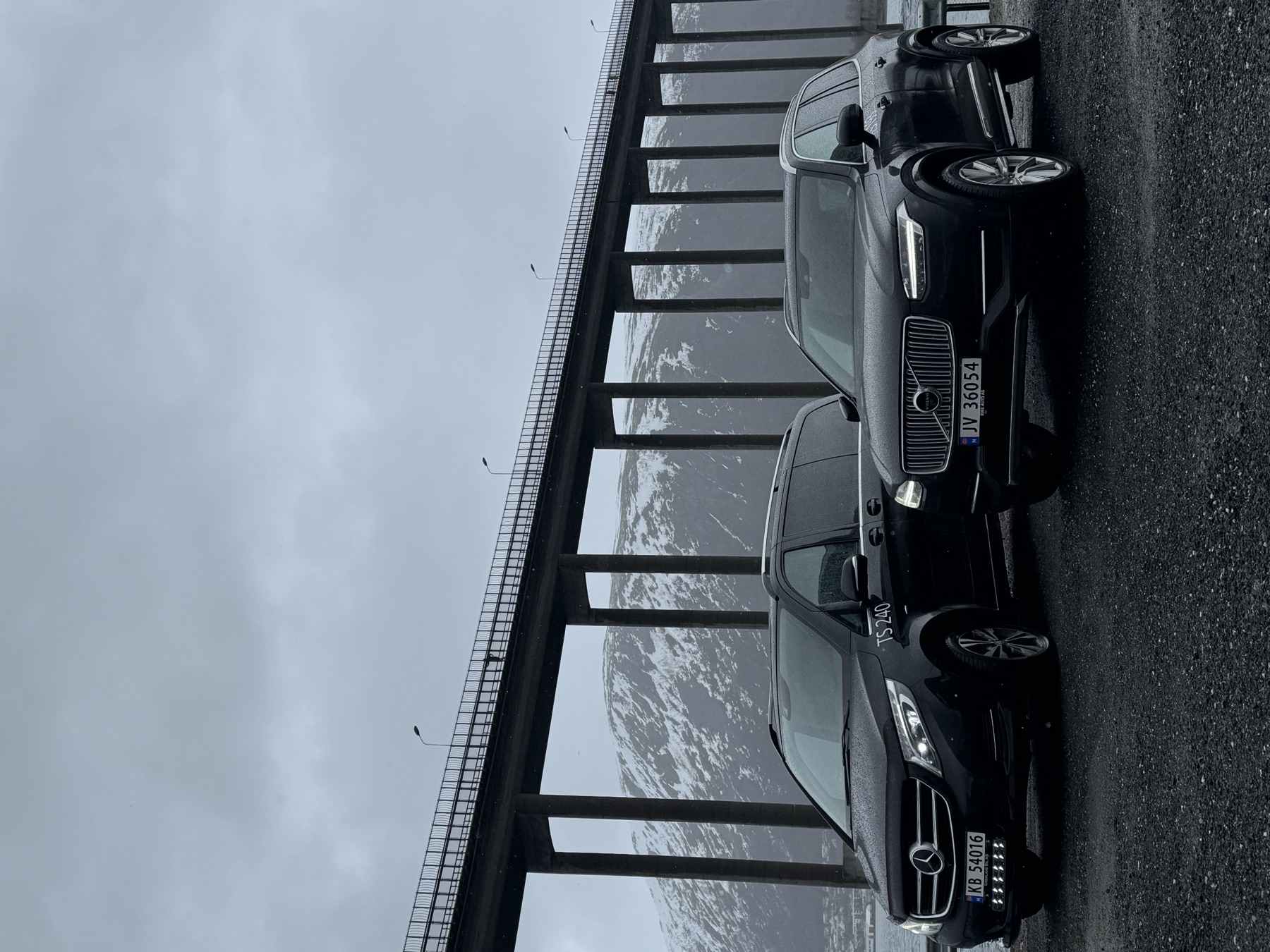 Northride's Mercedes V-Class and Volvo XC90 parked beneath the Tromsø Bridge
