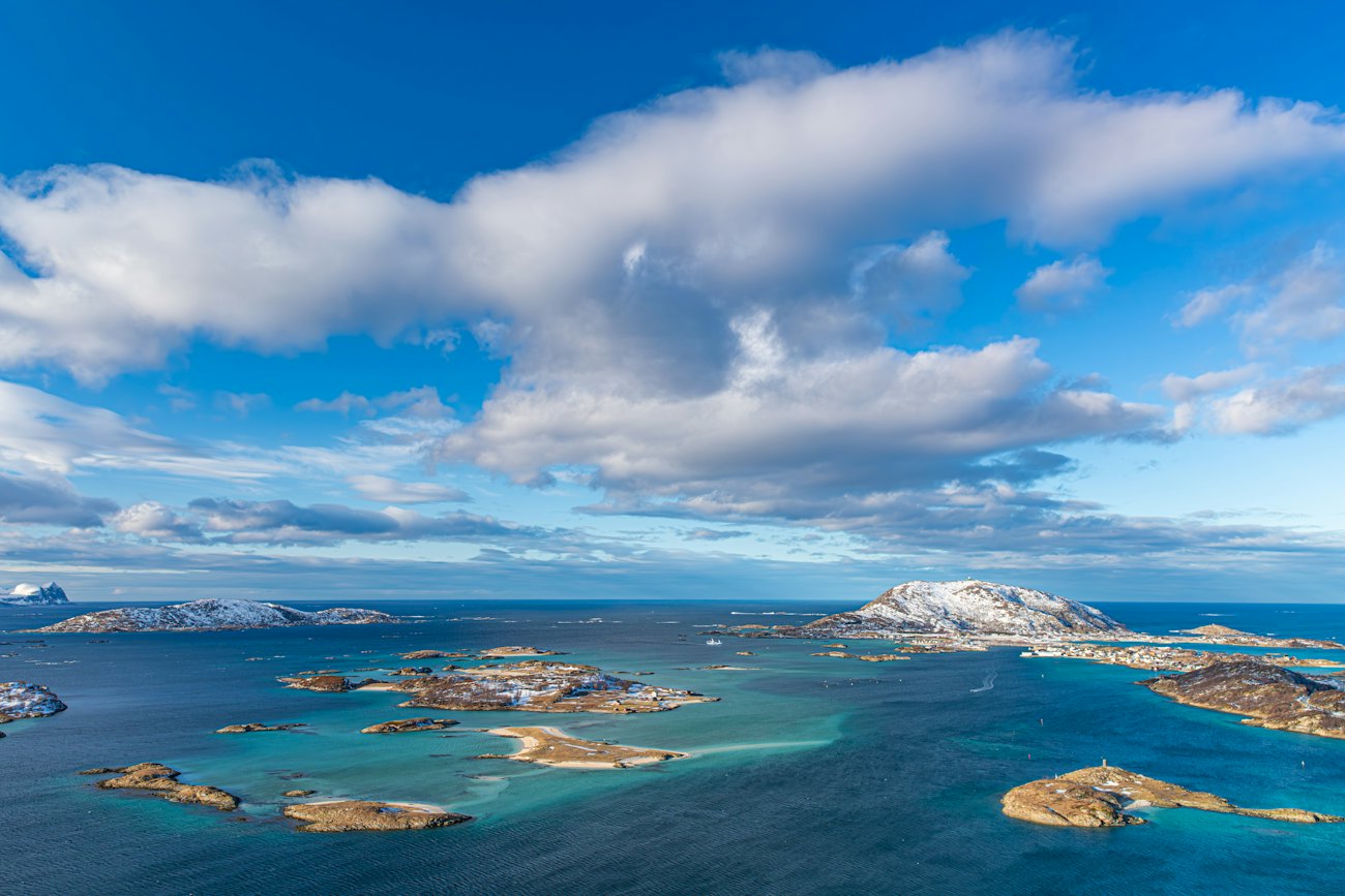 Turquoise sea and small islands off the outer coast under summer clouds